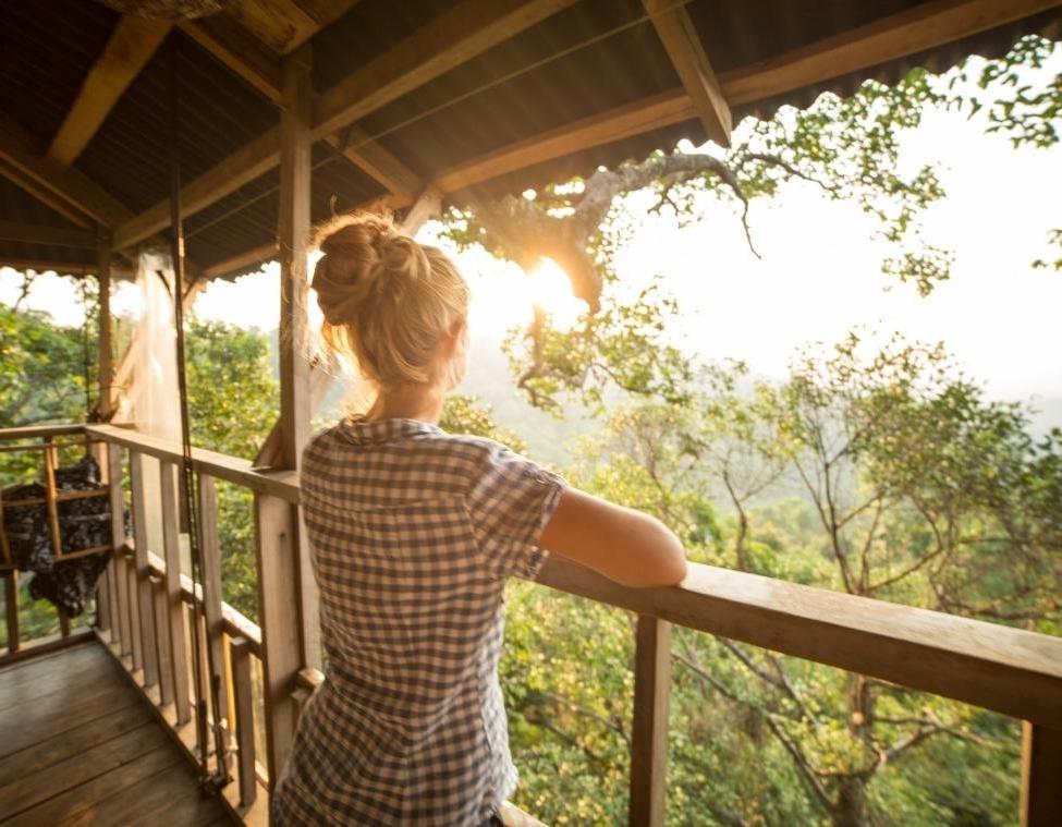 Female Looking at Sunset on porch